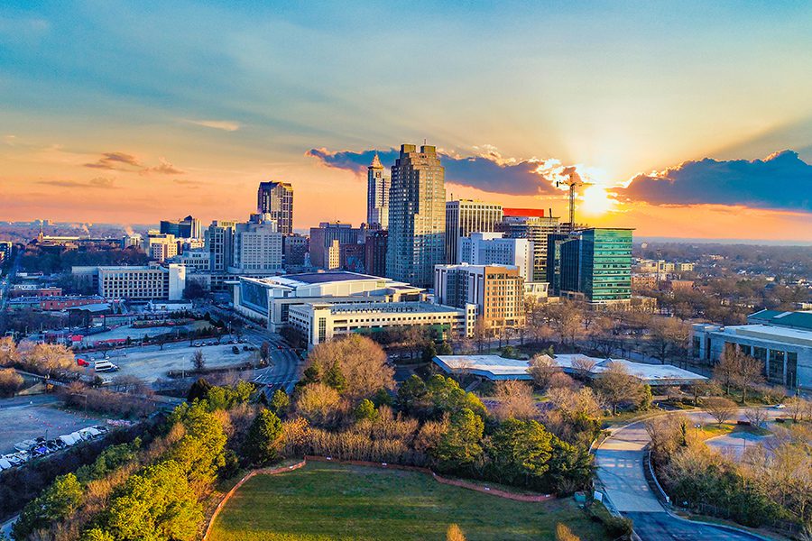 Contact - Aerial View of Downtown Raleigh, North Carolina Skyline at Sunset
